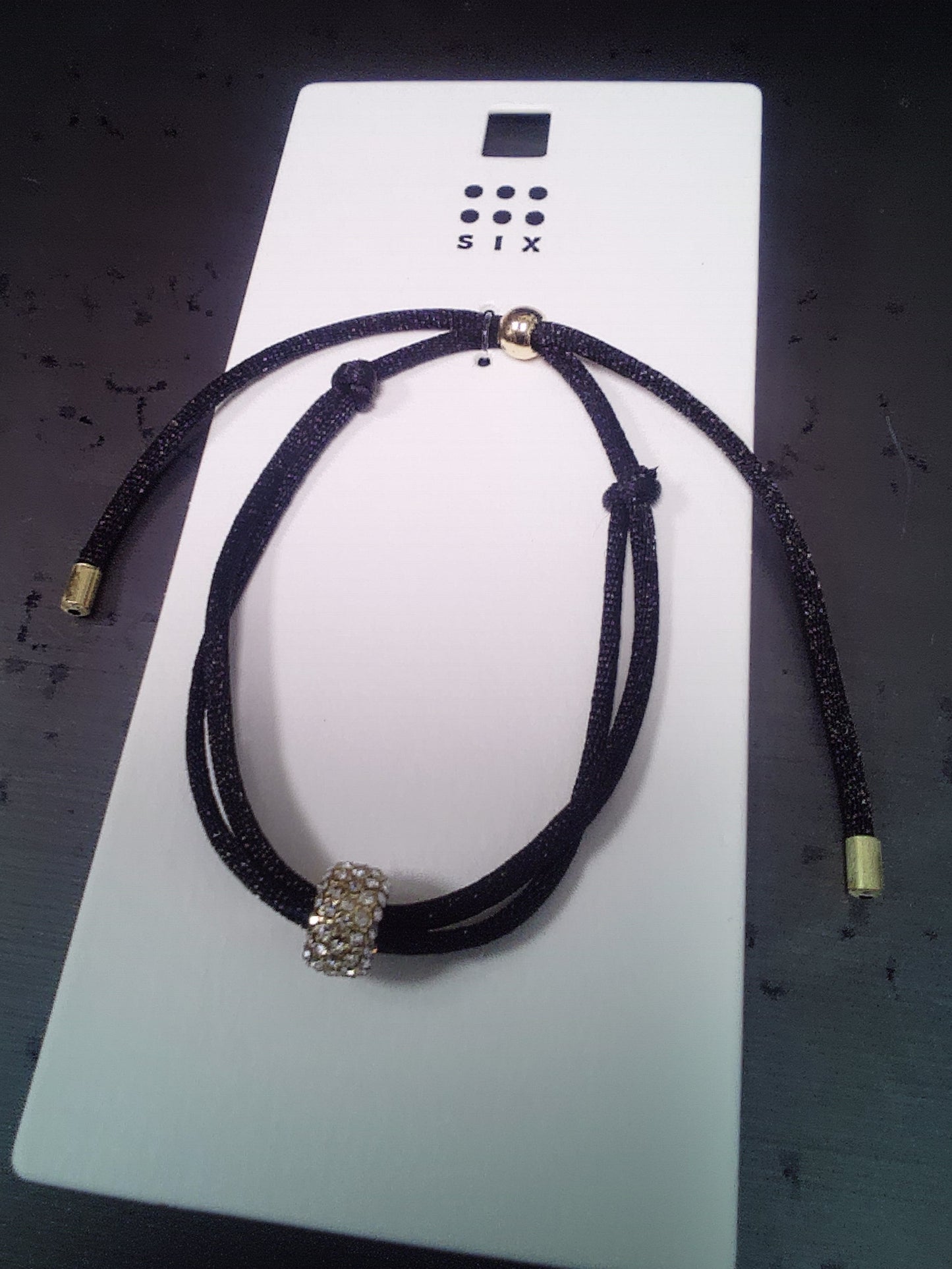 Black choker necklace with a magnetic rhinestone ball closure